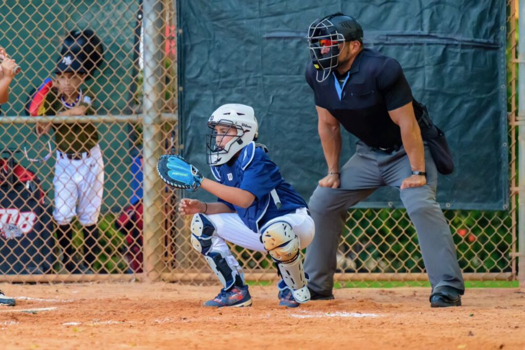 Young catcher in position behind home plate at a Coastline Select Baseball tournament