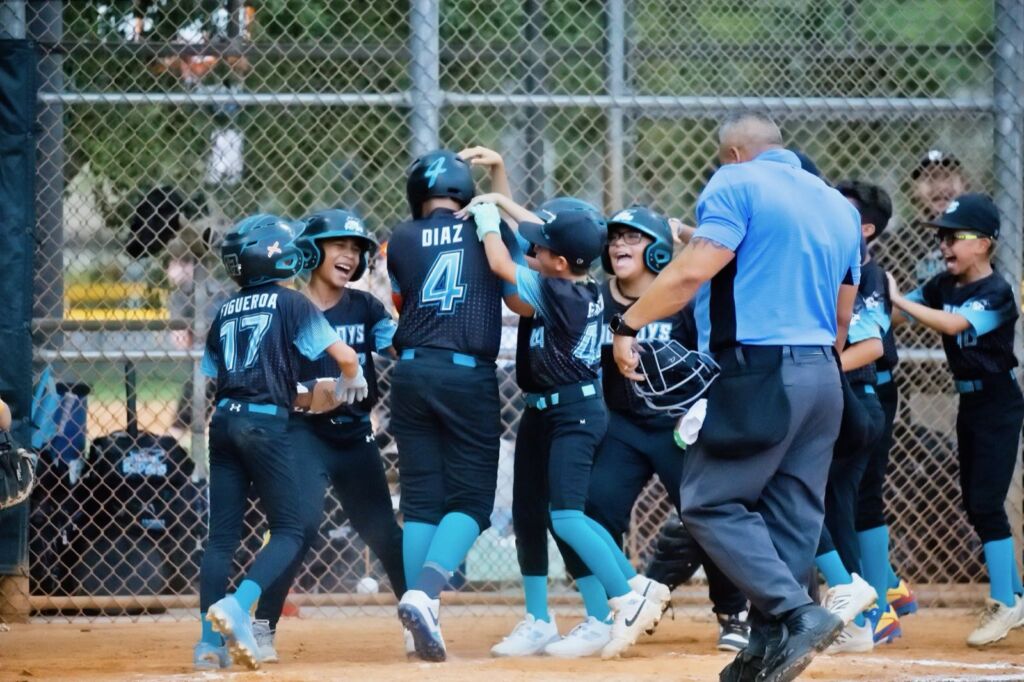 Coastline Select Baseball players celebrating at home plate after a home run