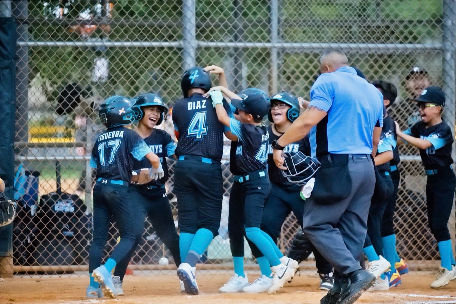 Coastline Select Baseball players celebrating at home plate during the Down South Invitational at JD Redd Park in Homestead, Florida